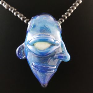 blue glass creature face pendant with white ghost eye