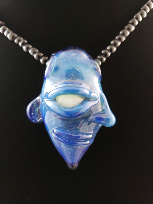 blue glass creature face pendant with white ghost eye