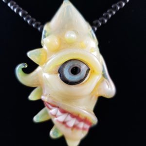 lampwork pendant side view blue eyed glass creature with sharp teeth