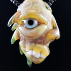 Blue eyed glass creature lampwork pendant with spines on the back