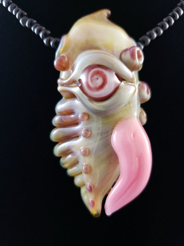 glass sea creature pendant with red and pink spiral eye