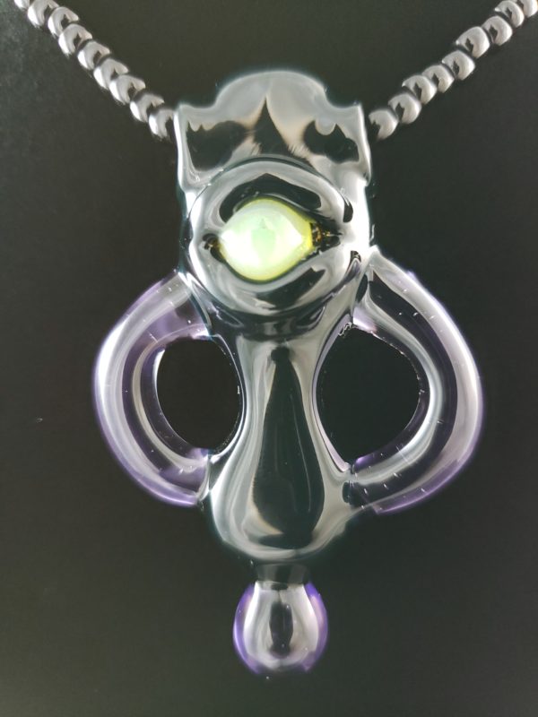 purple and black glass alien creature pendant with one green eye