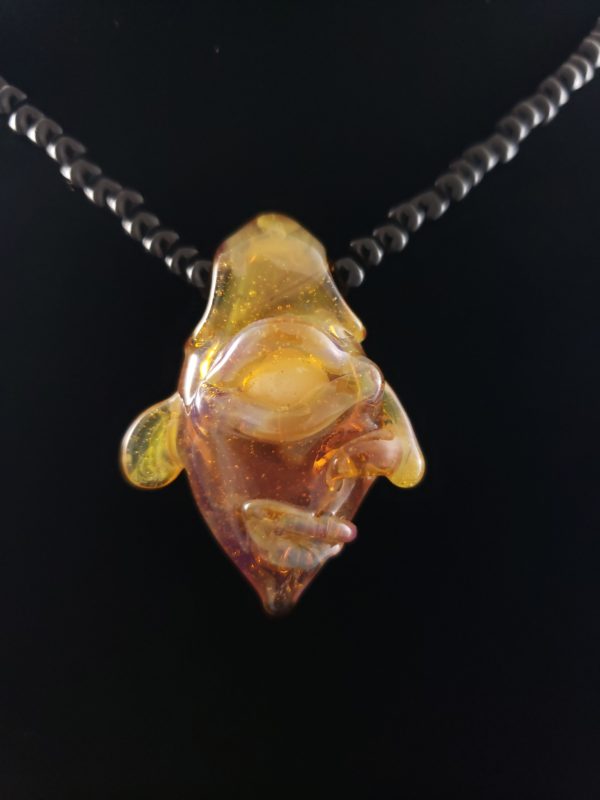 amber glass creature face pendant